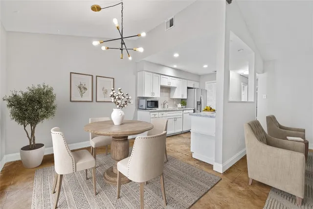 a living room with kitchen island furniture and a chandelier