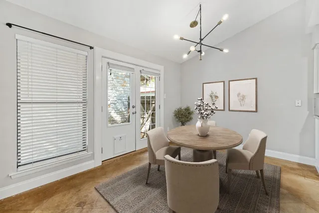 a dining room with furniture and window