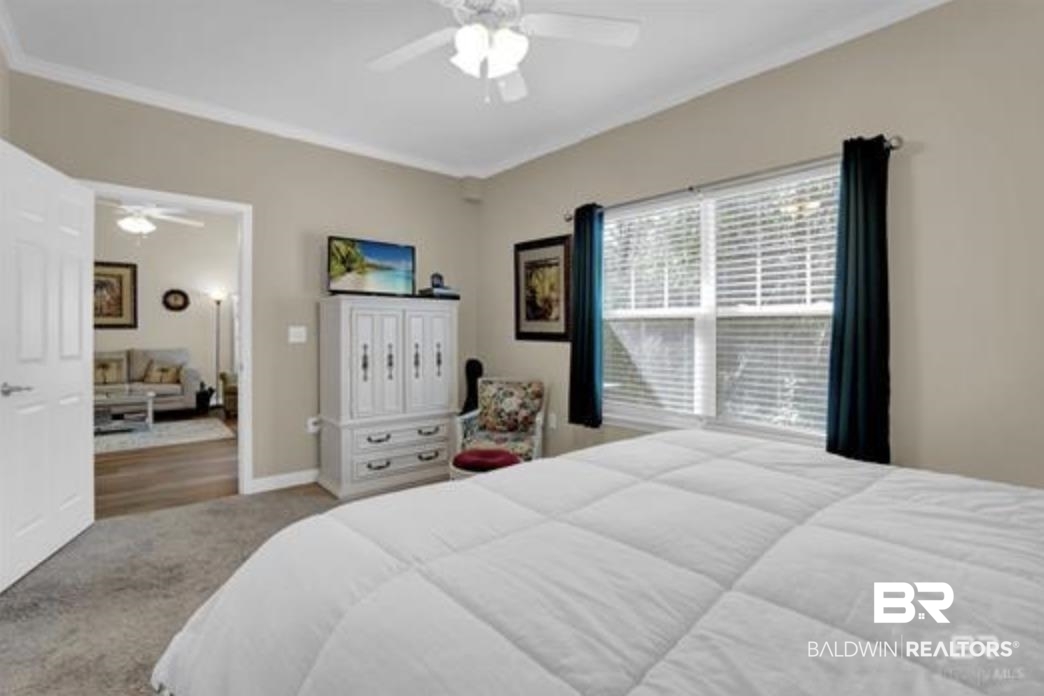 430 West Fort Morgan Road Gulf Shores, AL 36542 - Photo 15 of 27 Spacious room featuring neutral wall paint, white crown molding, and a ceiling fan