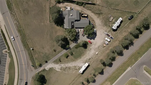 an aerial view of a house with a yard