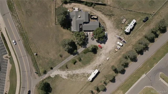 an aerial view of a house with a yard