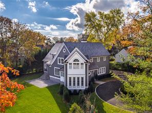 a view of a big house with a big yard and large tree