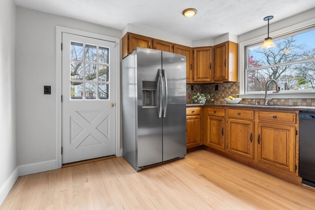 23 Yale Road Arlington, MA 02474 - Photo 15 of 37 a kitchen with stainless steel appliances a refrigerator sink and cabinets