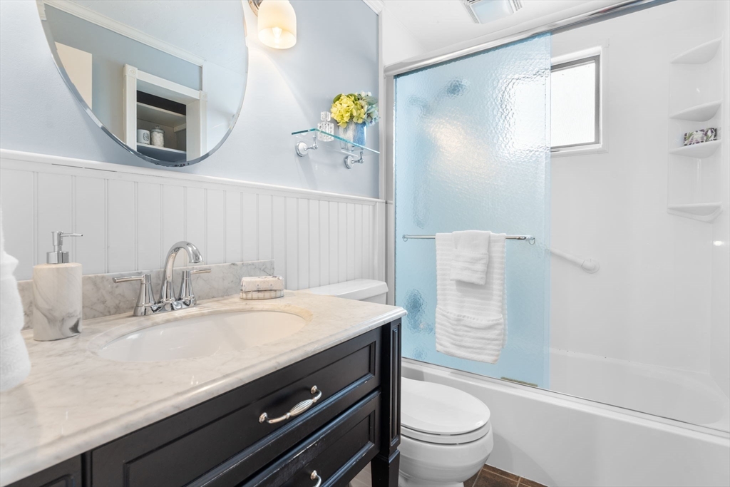 23 Yale Road Arlington, MA 02474 - Photo 17 of 37 a bathroom with a granite countertop sink a toilet and a mirror