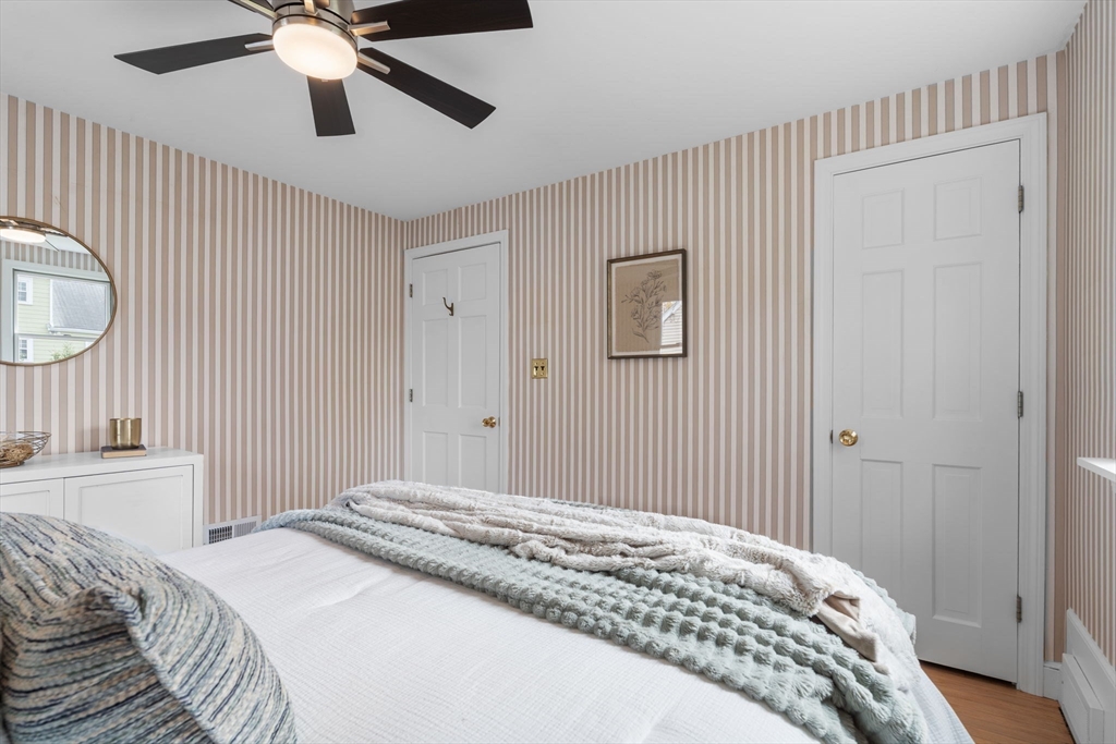 23 Yale Road Arlington, MA 02474 - Photo 20 of 37 a bedroom with a large bed and a chandelier