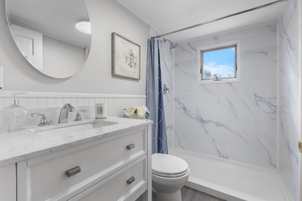 23 Yale Road Arlington, MA 02474 - Photo 24 of 37 a bathroom with a granite countertop sink mirror vanity and toilet
