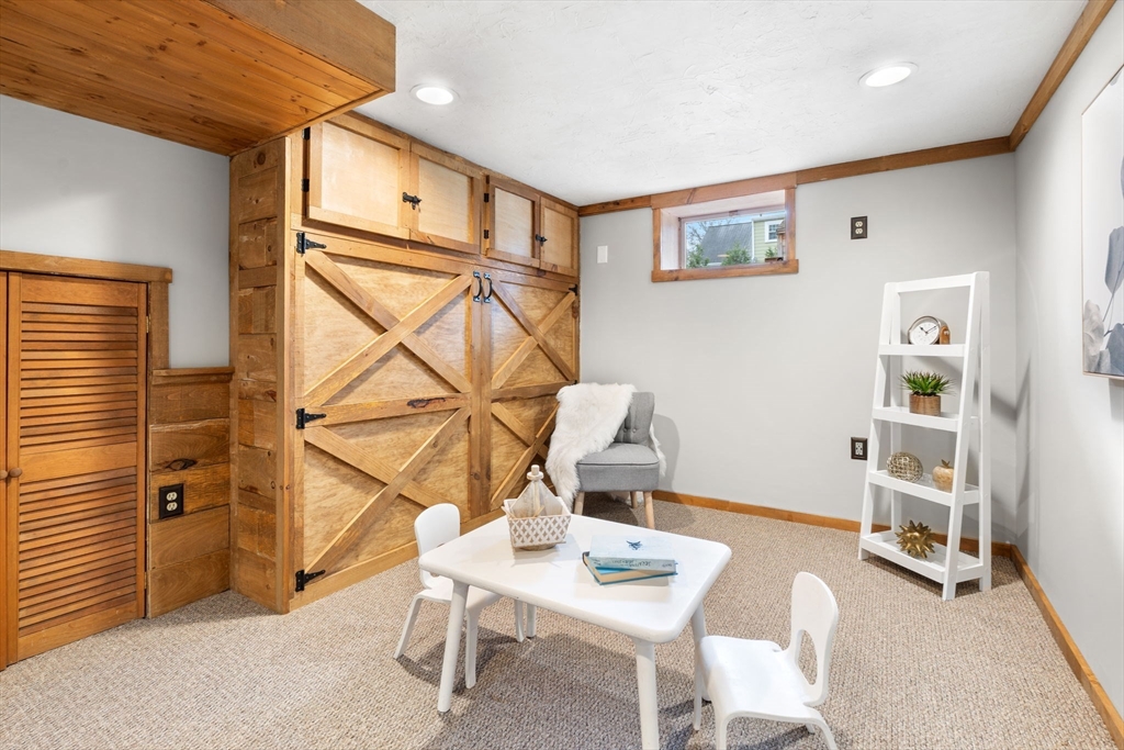 23 Yale Road Arlington, MA 02474 - Photo 30 of 37 a living room with furniture a flat screen tv and a table