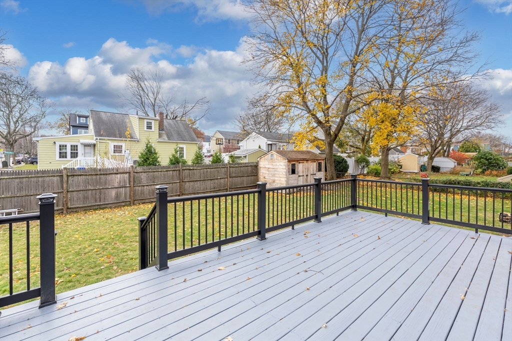 23 Yale Road Arlington, MA 02474 - Photo 4 of 37 a view of a deck with large trees and wooden fence
