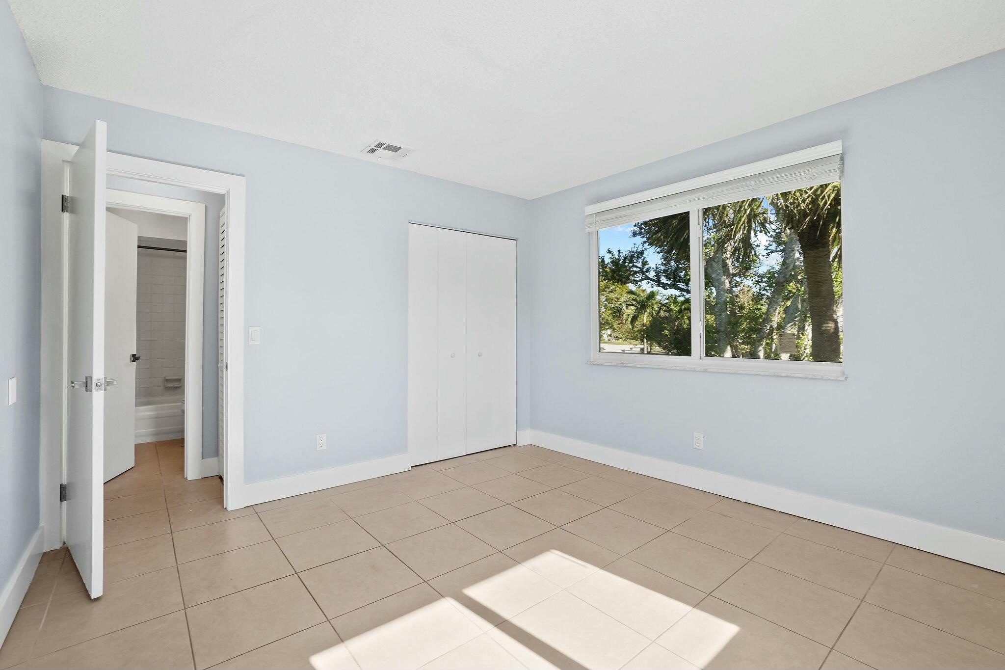983 Northwest Spruce Ridge Drive, Unit 4 Stuart, FL 34994 - Photo 19 of 56 a view of an empty room with window