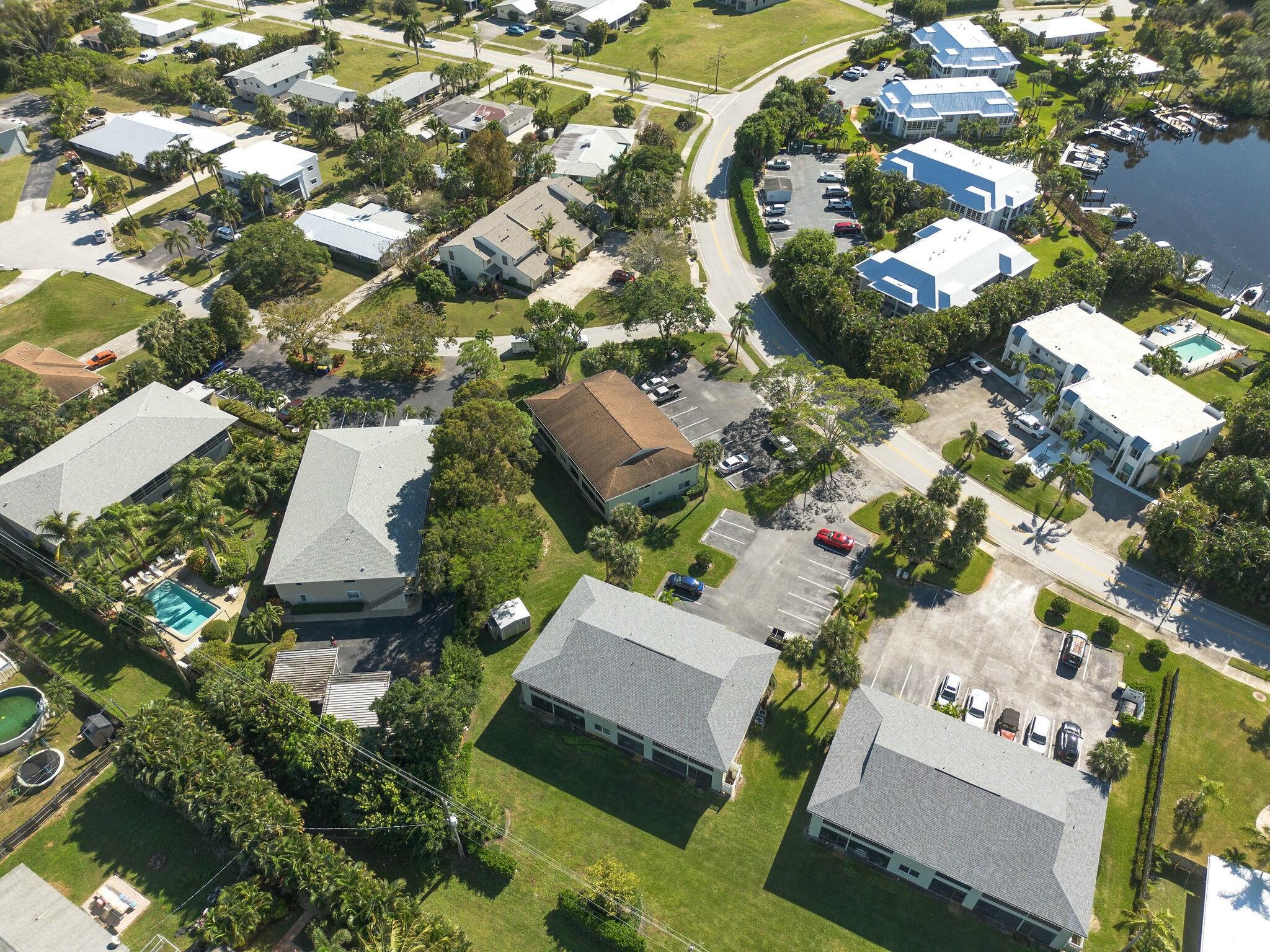 983 Northwest Spruce Ridge Drive, Unit 4 Stuart, FL 34994 - Photo 40 of 56 an aerial view of residential houses with outdoor space