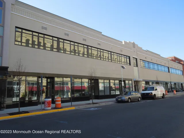 a view of building with cars parked