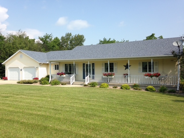 a front view of a house with a garden and porch