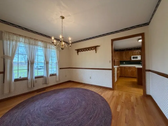 a view of an empty room with a kitchen