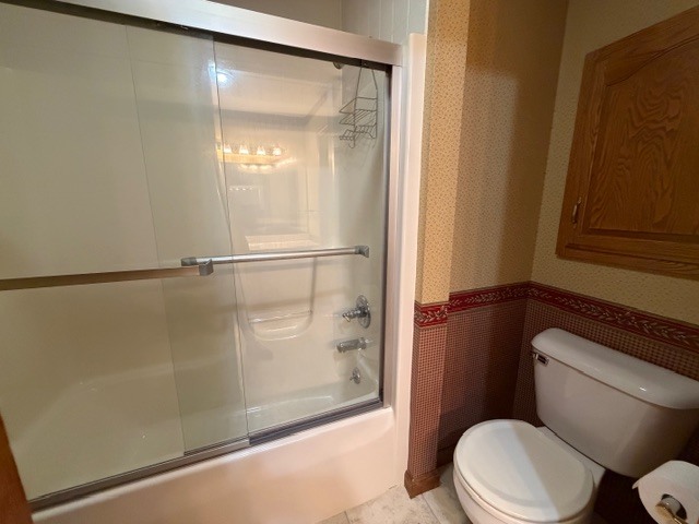 5897 Country Meadow Lane Clinton, IL 61727 - Photo 25 of 59 a white toilet sitting next to a bath tub and shower