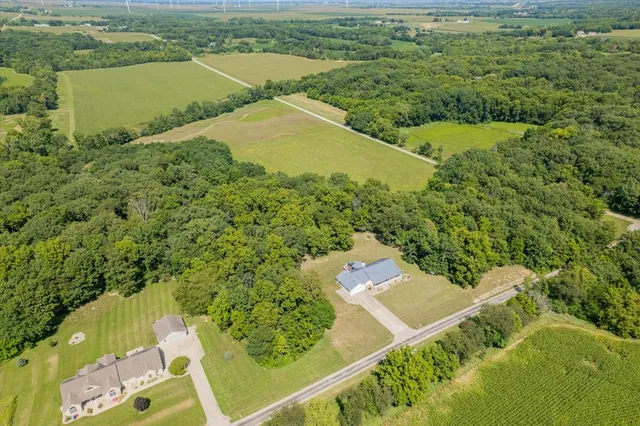 an aerial view of residential houses with outdoor space and river