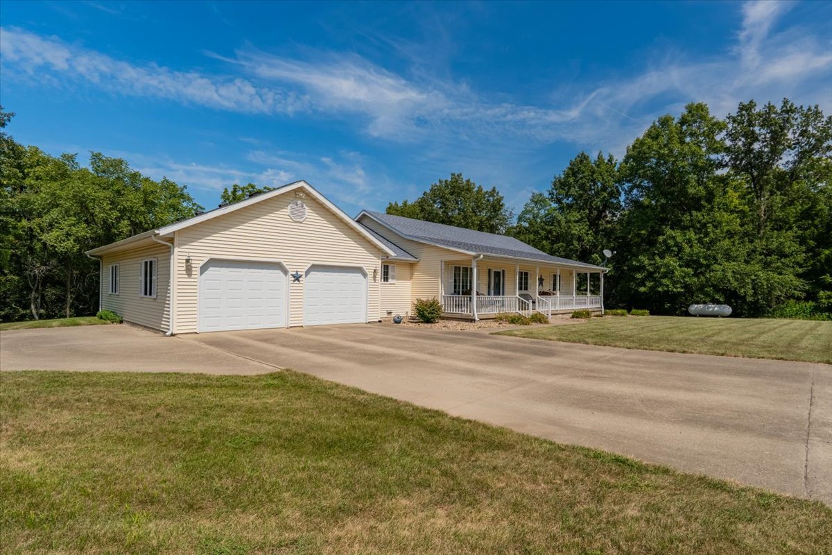 5897 Country Meadow Lane Clinton, IL 61727 - Photo 39 of 59 a front view of house with yard and trees in the background