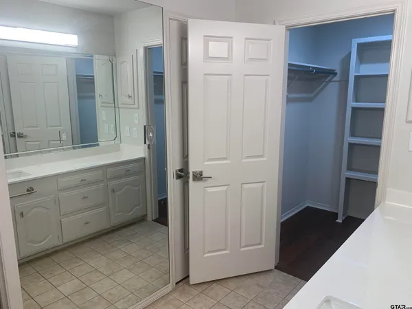 a bathroom with a double vanity sink and mirror