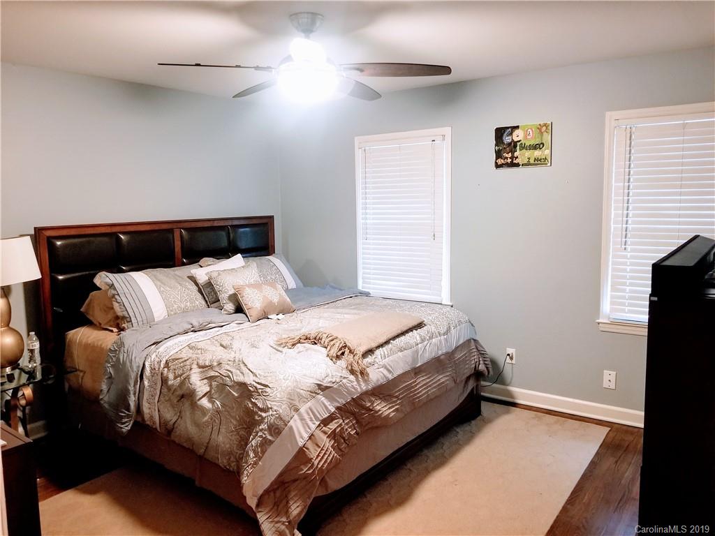 848 McAlway Road Charlotte, NC 28211 - Photo 3 of 9 a bed sitting in a bedroom next to a window