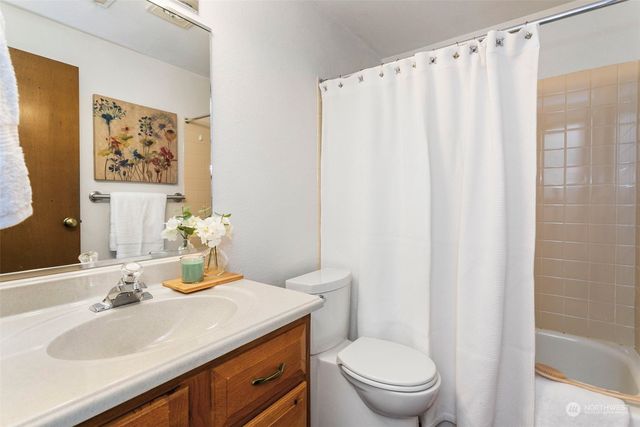 a bathroom with a sink toilet and a mirror