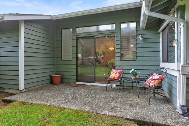a view of a house with a yard and lawn chairs with a yard