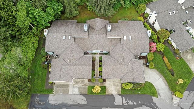 a aerial view of a house with a yard and potted plants
