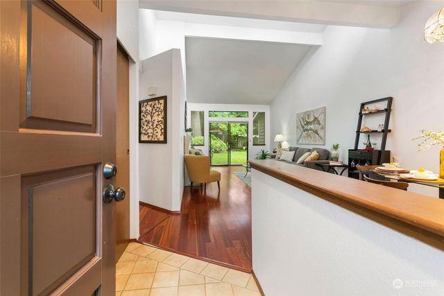 a view of a living room with furniture and a wooden floor