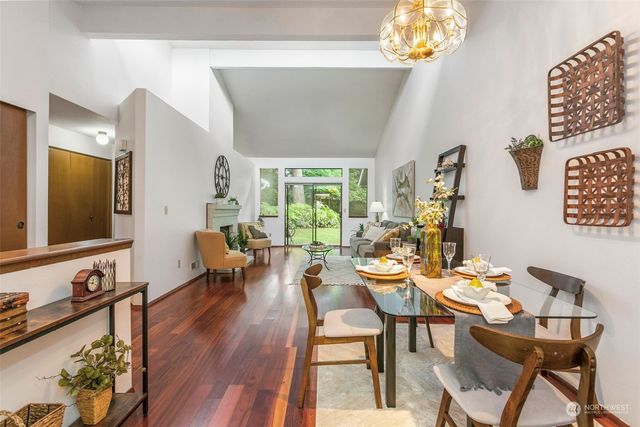 a view of a dining room with furniture a chandelier and wooden floor
