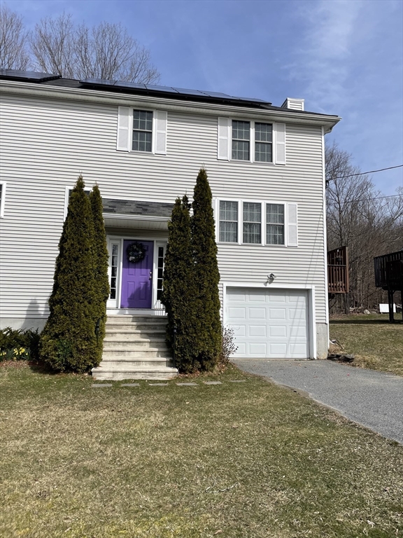 98 Upland Street, Unit 98 Worcester, MA 01607 - Photo 1 of 28 a front view of a house with a yard