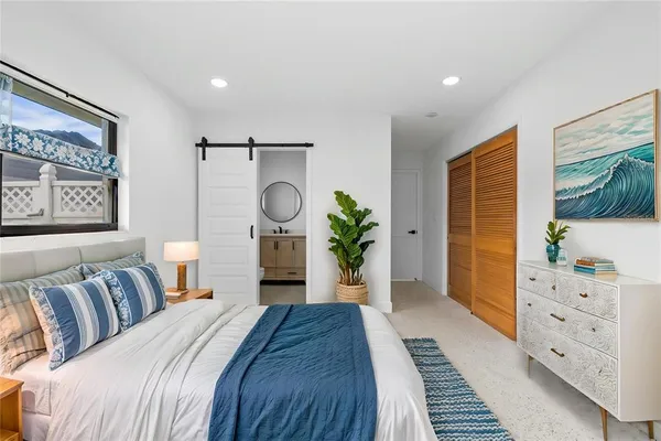 a bedroom with furniture and a potted plant