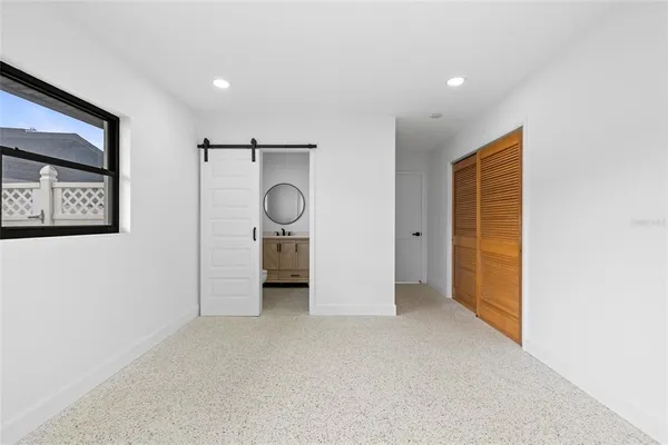 an empty room with window and cabinet