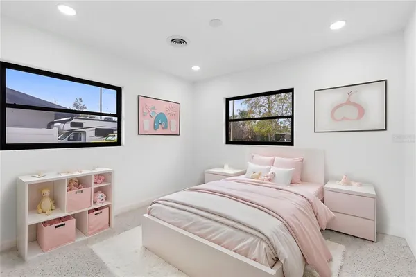 a bedroom with a bed and a painting on the wall