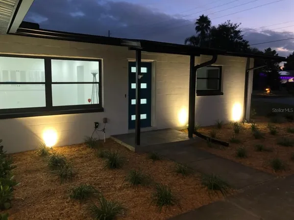 a night view of house and yard with green space