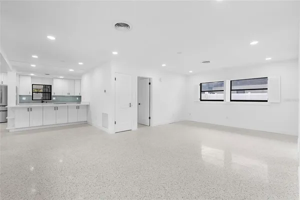 a view of a kitchen with kitchen island and stainless steel appliances