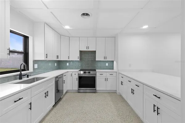 a kitchen with sink cabinets and stove