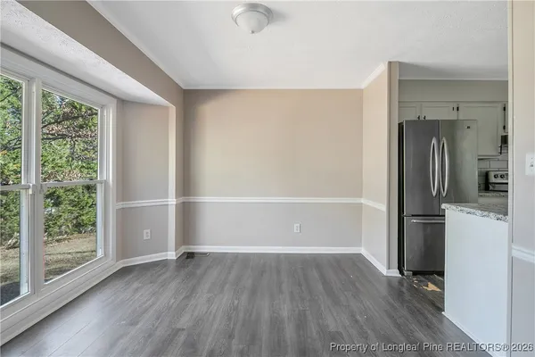 a kitchen with stainless steel appliances a refrigerator and a stove top oven
