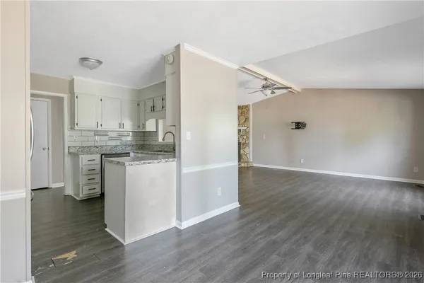 a kitchen with a sink cabinets and window