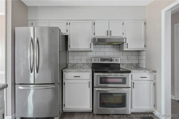 a bathroom with a bathtub shower sink vanity and toilet