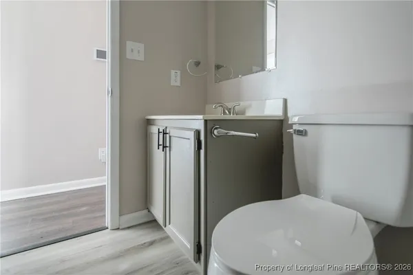 a view of a big room with chandelier fan and windows