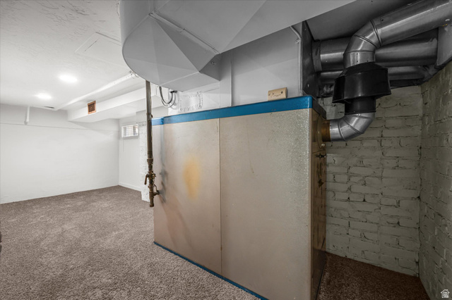 327 35th Street Ogden, UT 84401 - Photo 26 of 31 Carpeted lower level room with recessed lighting, painted brick wall, and visible utility infrastructure