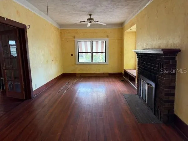 wooden floor in an empty room with a window