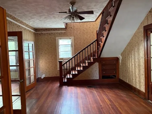 a view of entryway with wooden floor and stairs