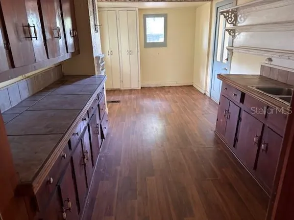 a view of an entryway with wooden floor