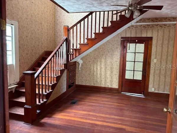 a view of an entryway wooden floor and front door