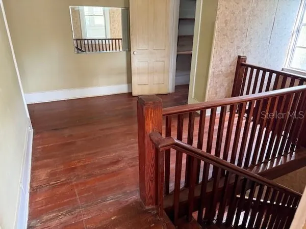 a view of staircase with railing and a window