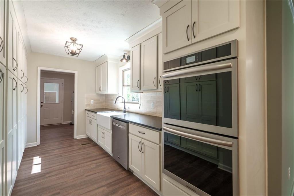 2635 Preston Road Good Hope, GA 30641 - Photo 14 of 68 a kitchen with cabinets stainless steel appliances and wooden floor