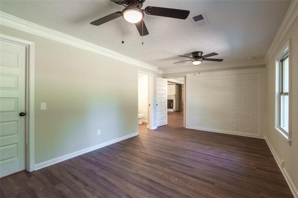 2635 Preston Road Good Hope, GA 30641 - Photo 24 of 68 an empty room with wooden floor chandelier fan and windows