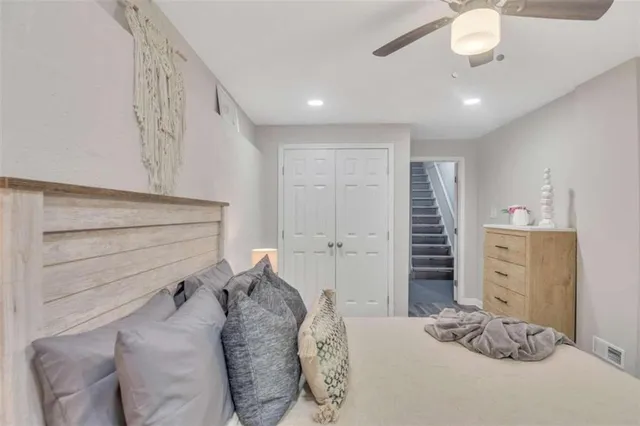 a bedroom with a bed and cabinets