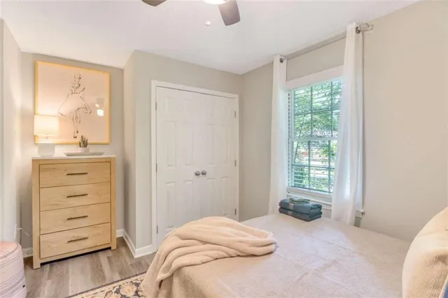 a bedroom with a bed and painting on the wall