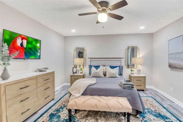 a bedroom with a bed and a flat screen tv