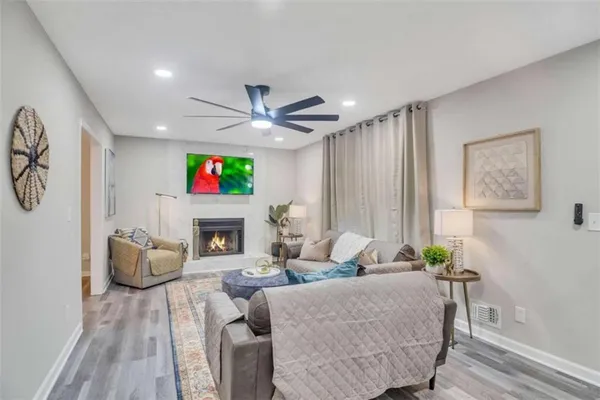 a living room with fireplace furniture and a large window